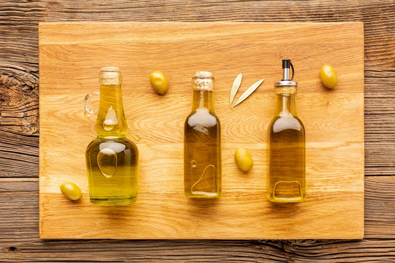 20230514063422_[fpdl.in]_olive-bottles-yellow-olives-leaves_23-2148349414_medium